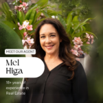 Alt text: "Image of Melanie Higa, a seasoned real estate agent with 18+ years of experience, smiling confidently in front of a lush backdrop with pink flowers. The text overlay introduces her as 'MEET OUR AGENT Mel Higa' emphasizing her extensive experience in the industry."